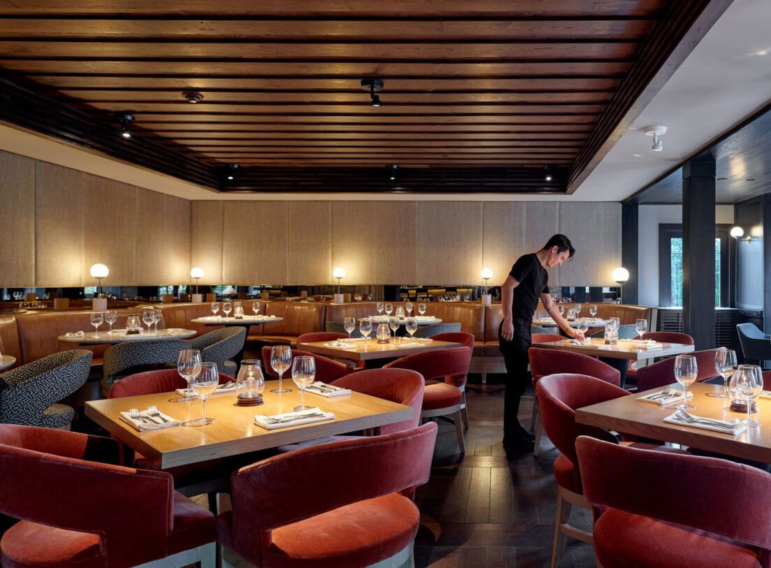 Terrace Room Dining Room View of the Terrace Room dining room with romantic lighting and server arranging tableware